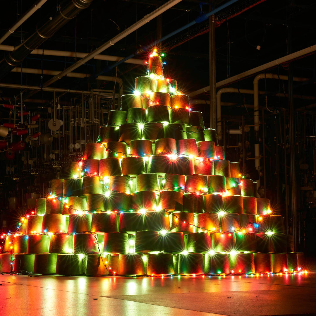 A Christmas tree made of merino wool yarn cones, set up in the Darn Tough mill