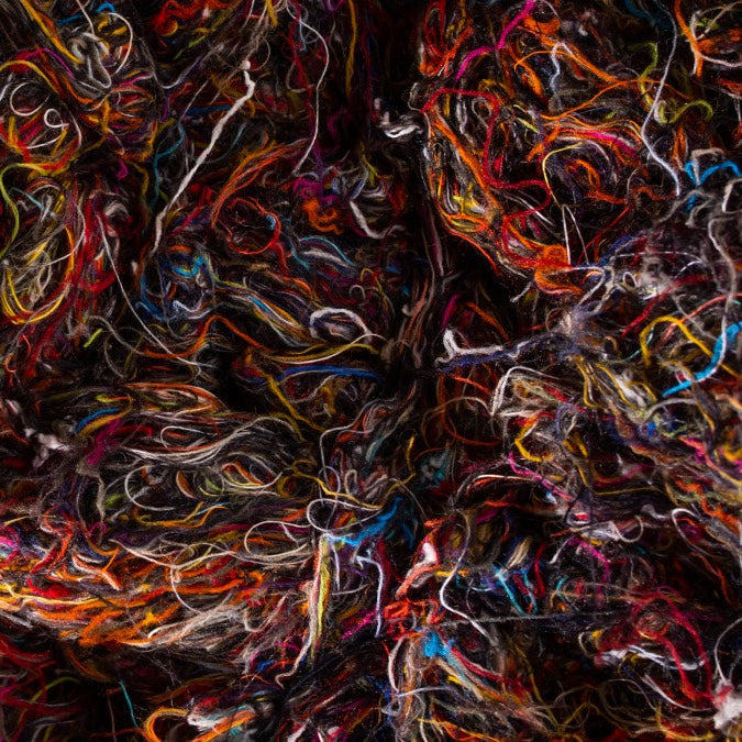 A pile of merino wool fibers, which are super soft, not itchy despite the myth