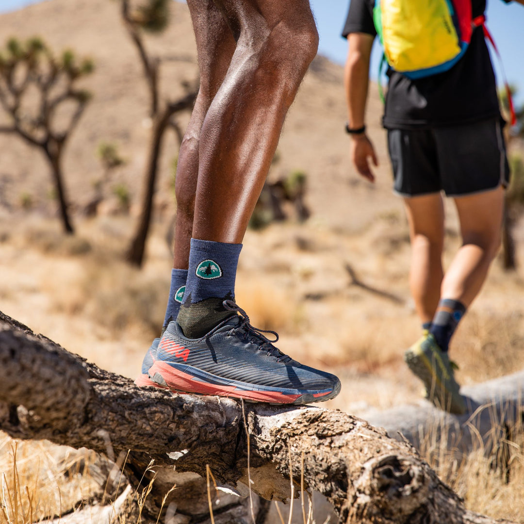 A man hiking in hot weather wearing breathable merino wool socks