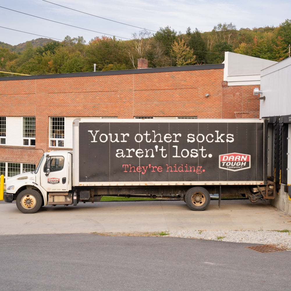 Darn Tough's box truck, which reads "your other socks aren't low. they're hiding"