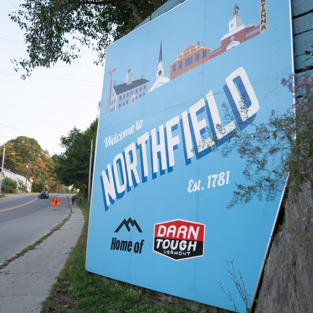 A sign saying "welcome to Northfield home of Darn Tough Vermont"