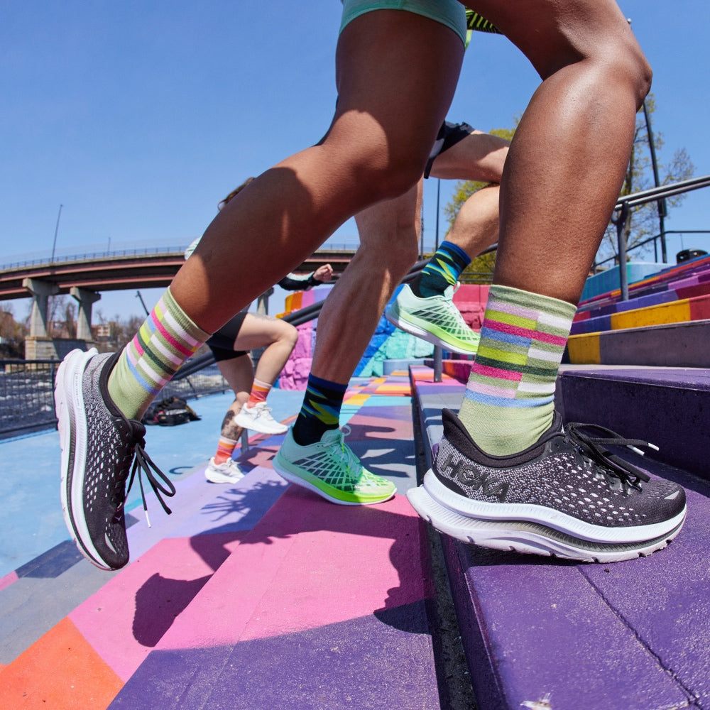 A group of runners wearing different socks headed up some stairs