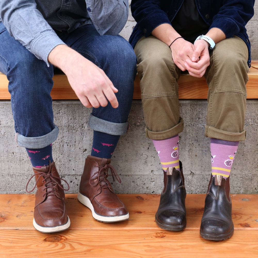 A couple's feet next to each other wearing matching Darn Tough socks for Valentine's Day