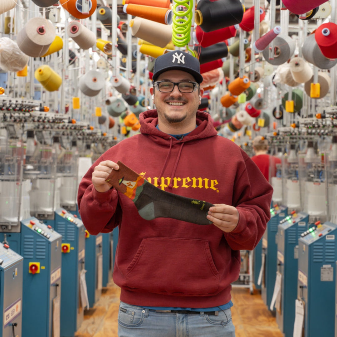Travis from Darn Tough holding up the Spaced Out Micro Crew sock for his birthday staff pick.
