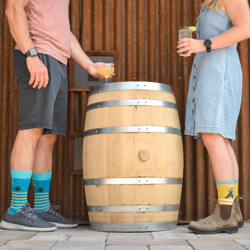 Two people having drinks in Darn Tough animal socks