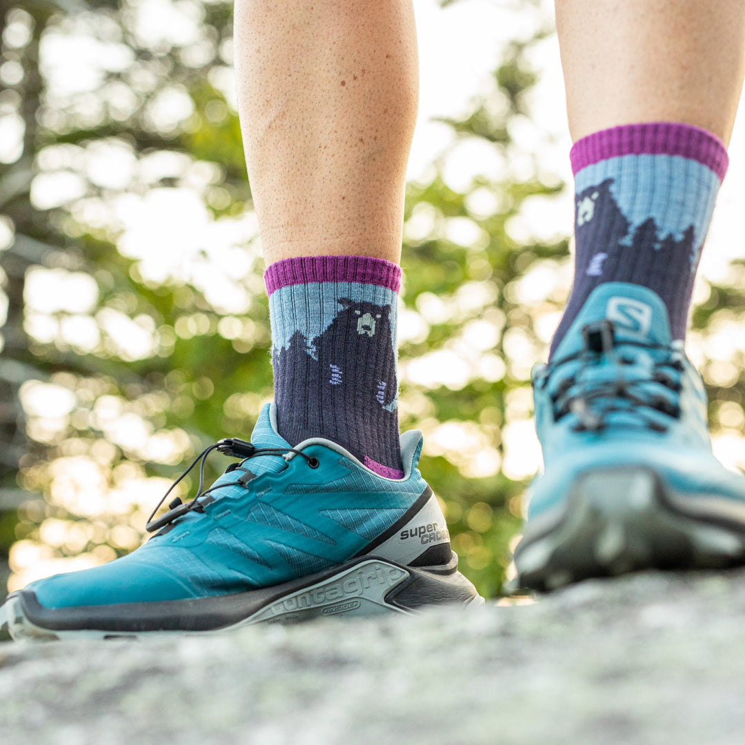A woman wearing darn tough bear town socks, a great gift for mom