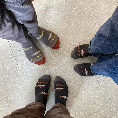 Bird's eye view of three people standing in a circle wearing Darn Tough Spey Fly Crew Socks