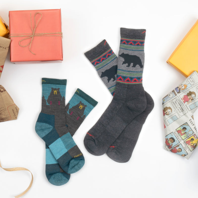 Darn tough socks with bears on them next to Christmas presents, because socks are a great gift