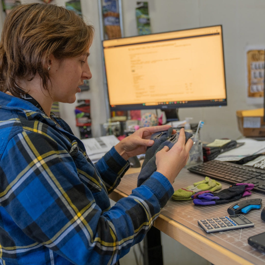 Warranty team member inspecting a returned sock