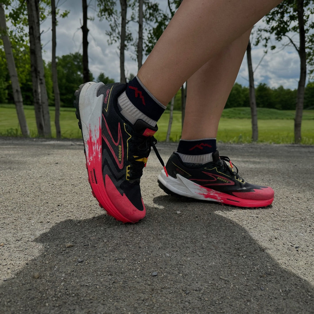 Kate's feet wearing her running shoes and the original Darn Tough running socks