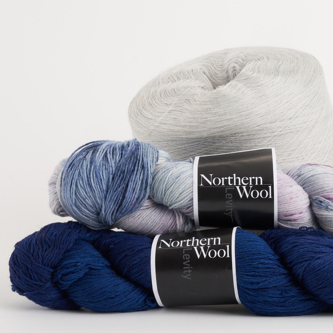 Northern Wool from Bobolinks next to a cone of Darn Tough merino wool yarn, used to make socks