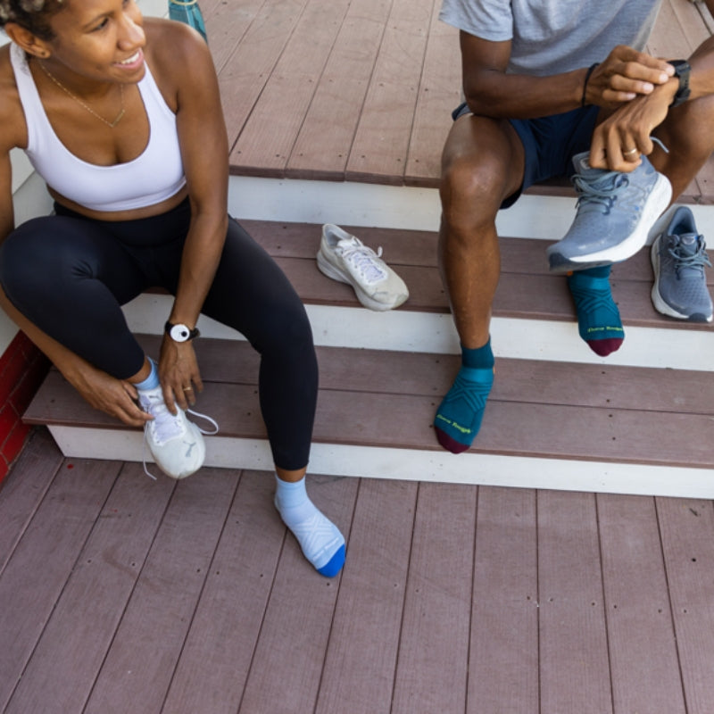 Two people getting ready for a run in Darn Tough running socks
