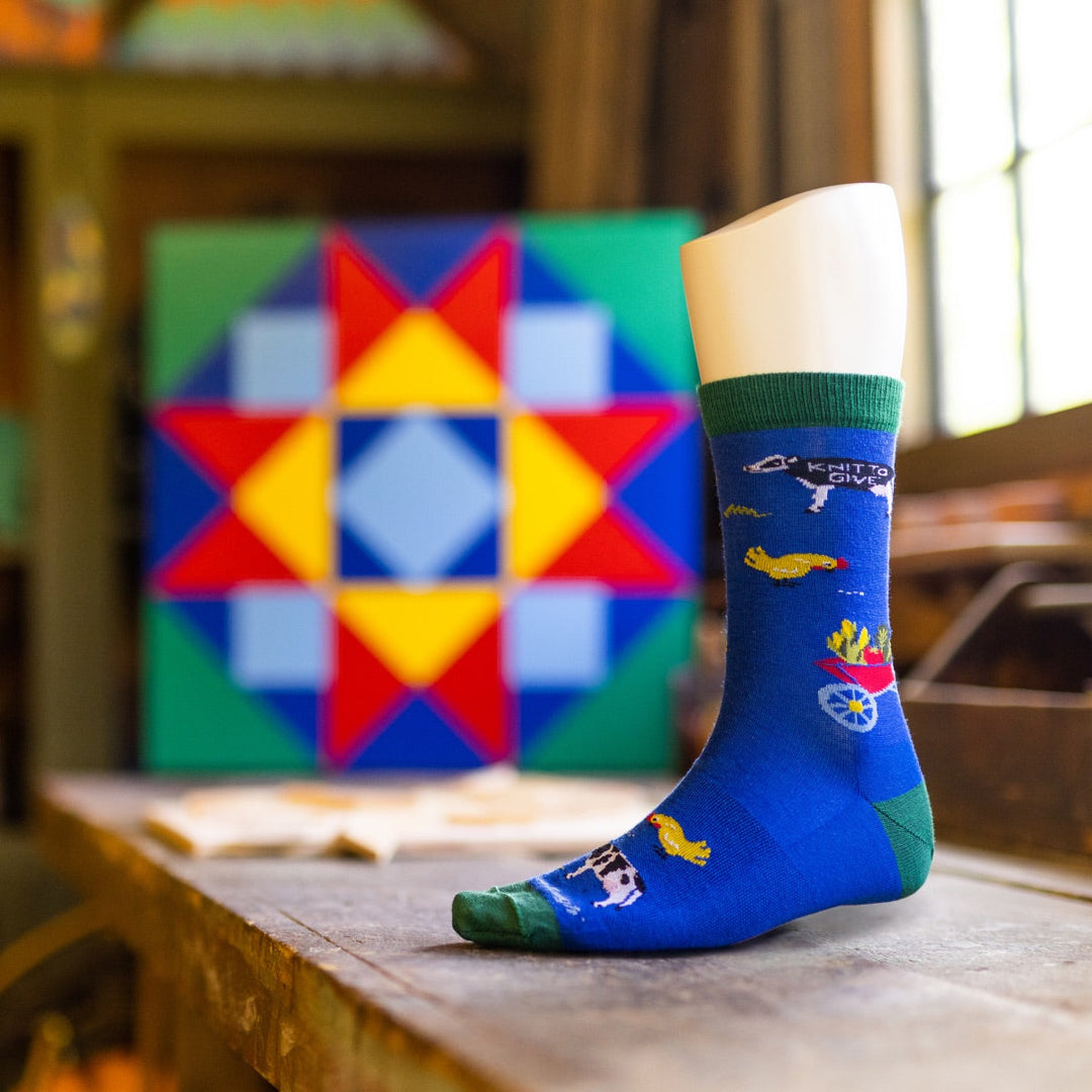 Darn Tough's first Knit to Give sock, the Barnyard, a blue lifestyle sock with farm animal designs