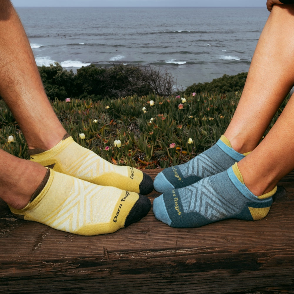 Two pairs of feet wearing coordinated run socks, perfect as a valentine gift