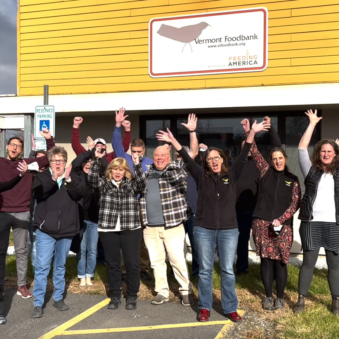 Vermont Foodbank employees jumping for joy that Darn Tough reached a million donated meals