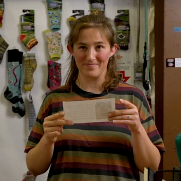 A Darn Tough employee reading a letter from a dog about eating socks