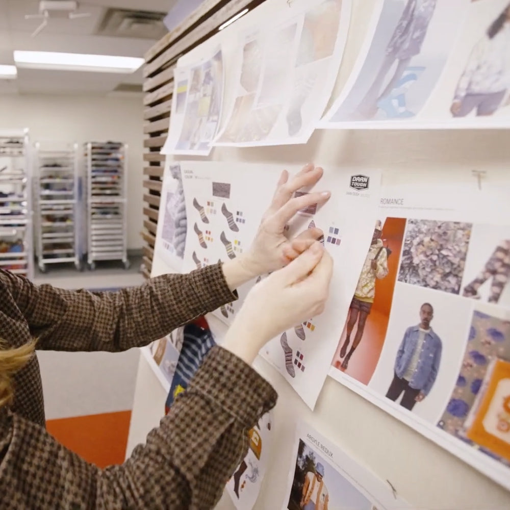 A designer putting a sock idea on a mood board