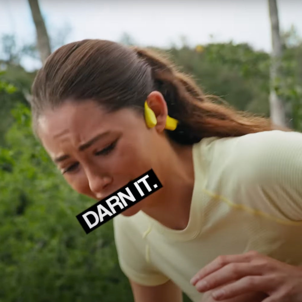 A woman choking with her mouth censored with the phrase "Darn It"