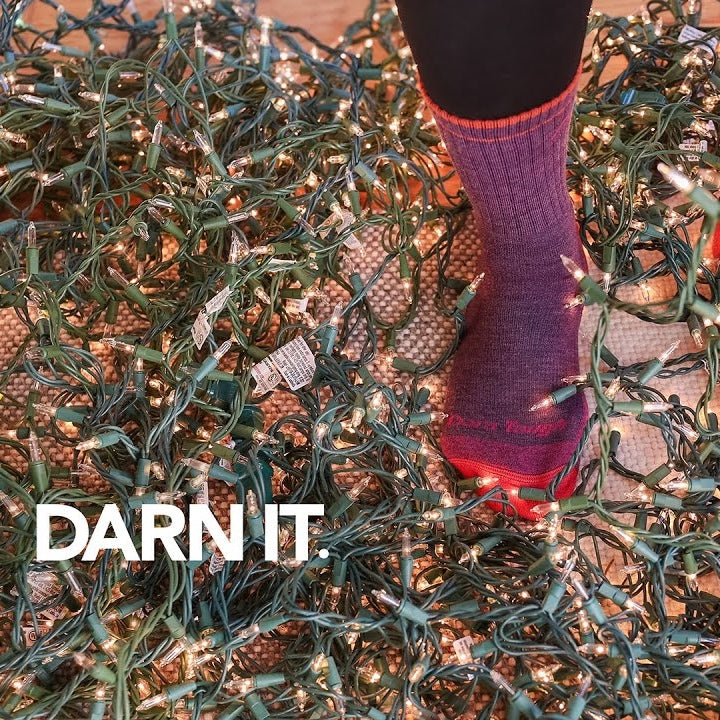 Darn It - feet wearing Darn Tough socks surrounded by a mess of Christmas lights