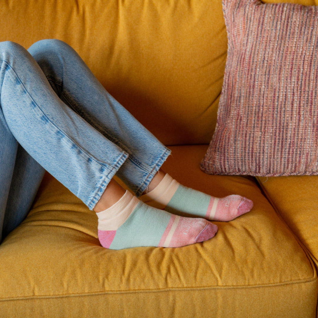 Person wearing cozy socks sitting on couch