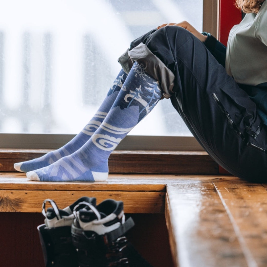 Person sitting on bench wearing Women's Swirlwind snow socks