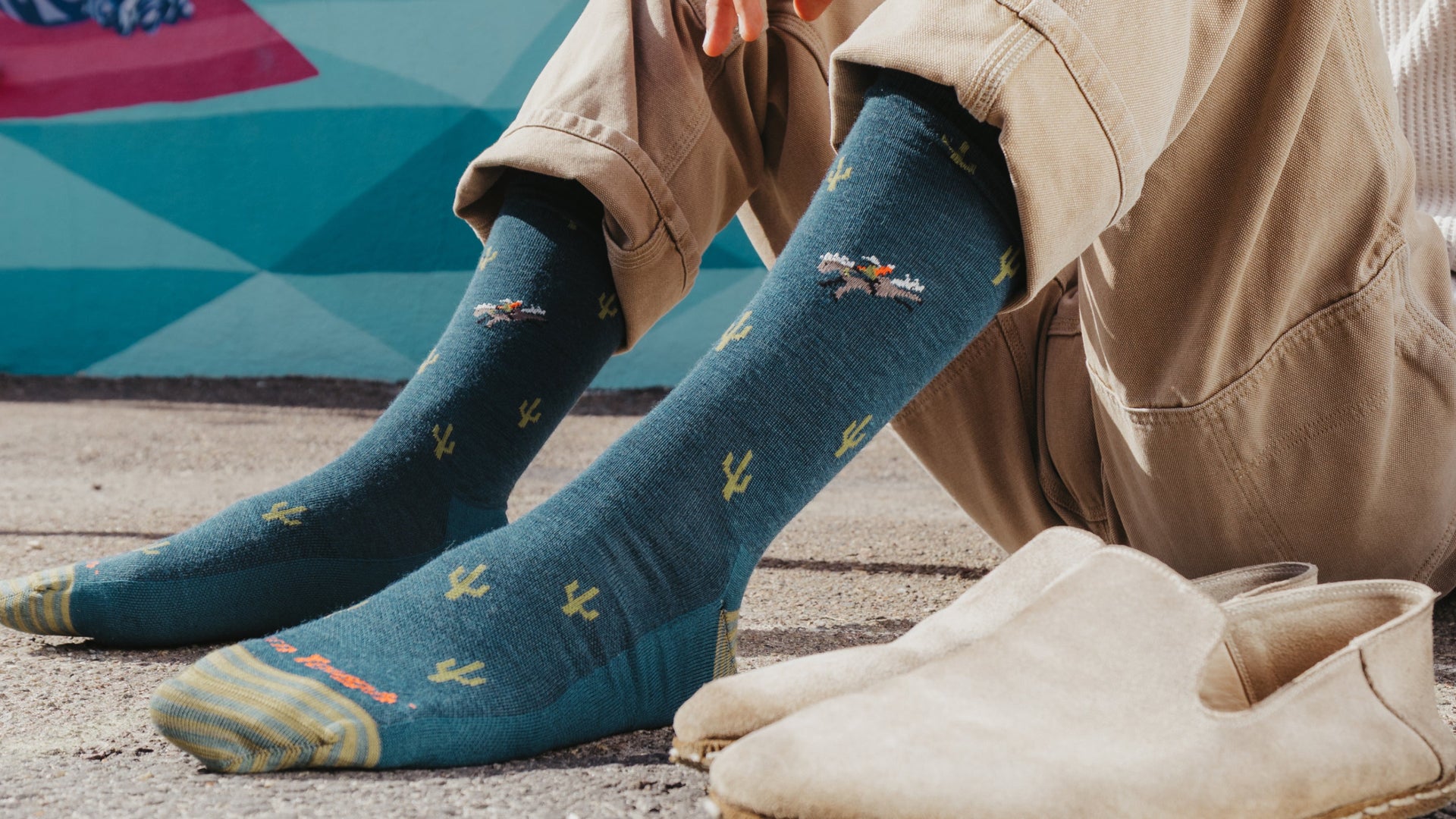 Models feet next to loafers wearing the woold woold west crew sock