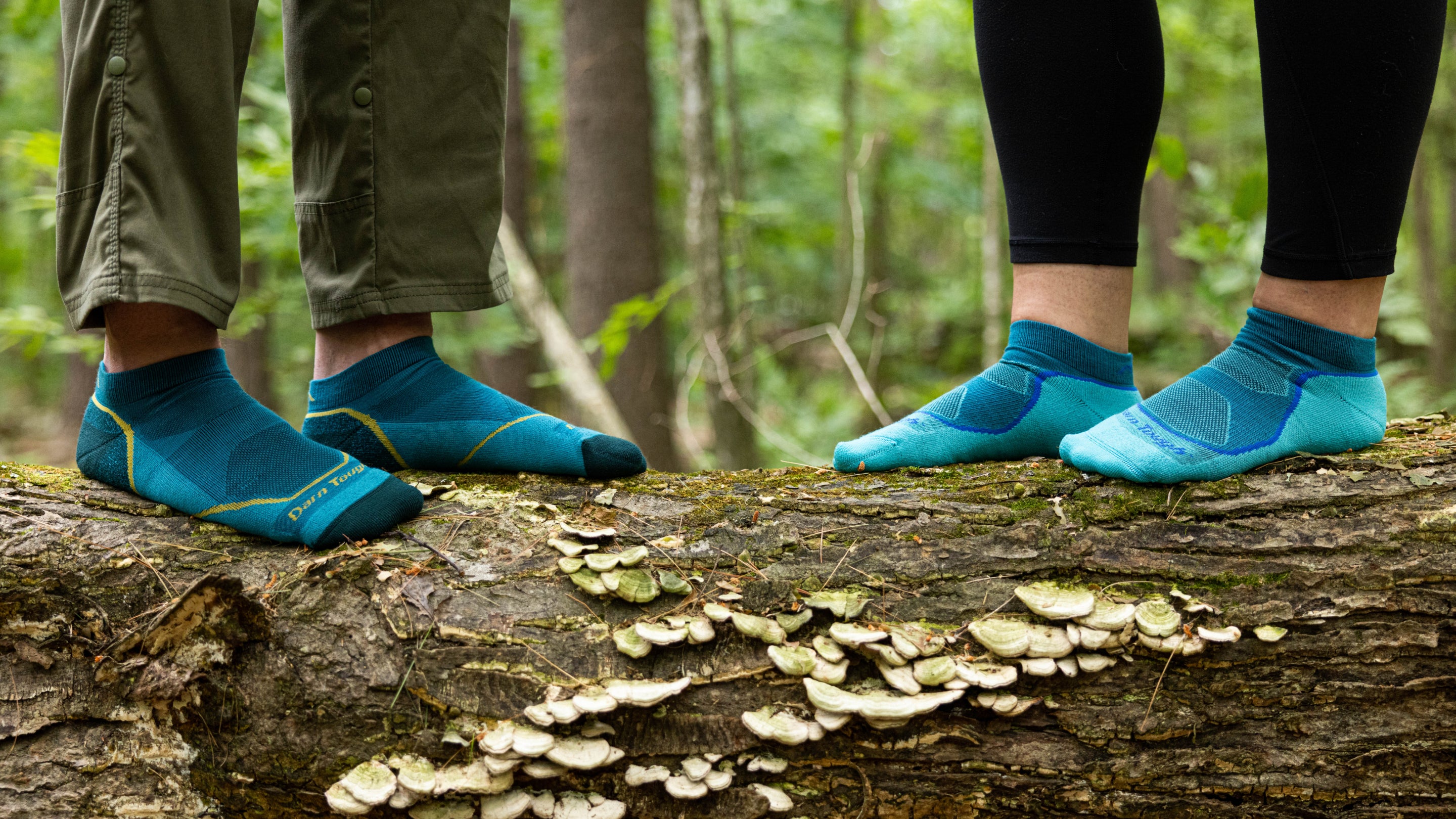 Men and women's no show Light Hiker being featured on model standing on a log. 