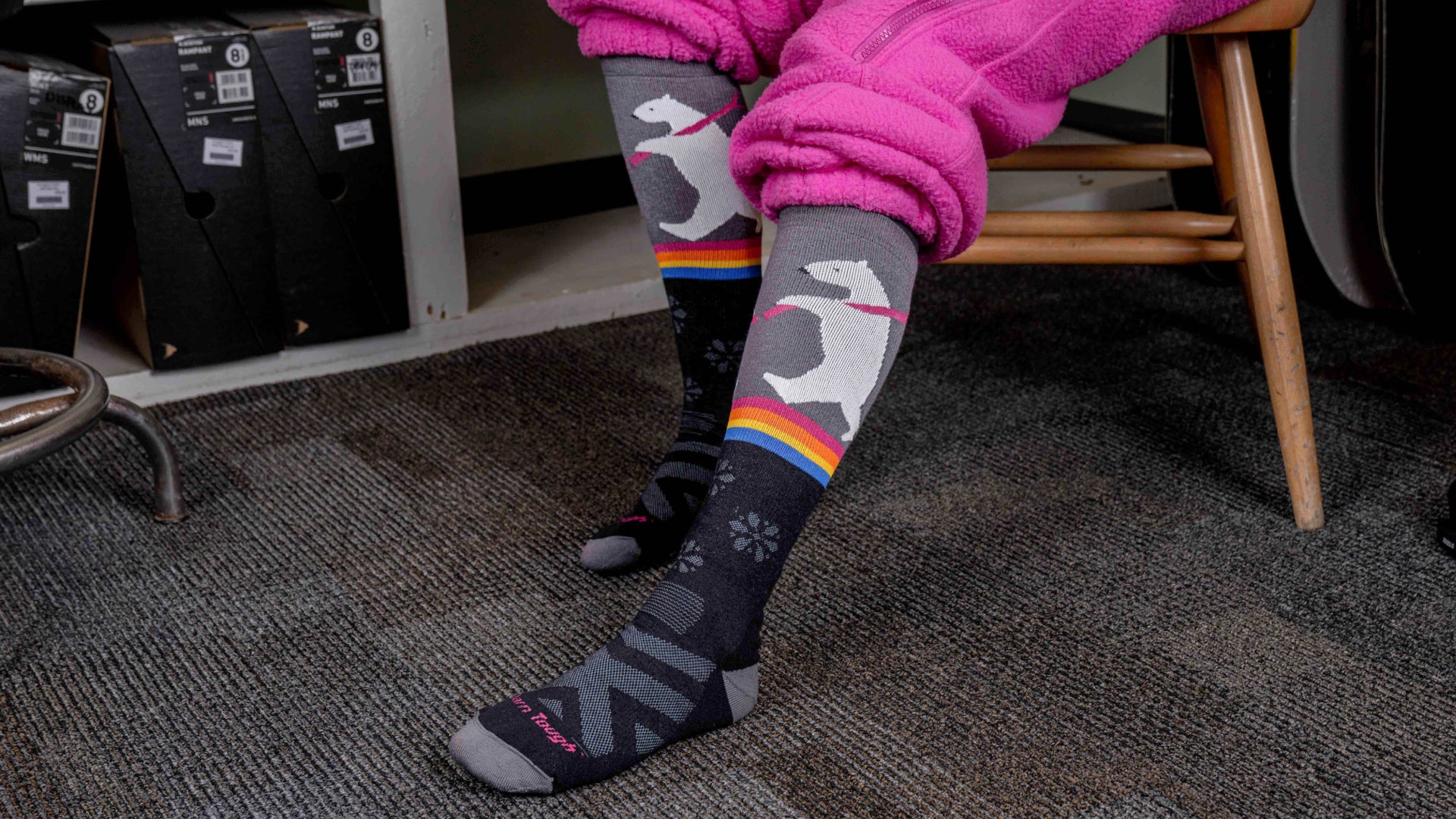 Model putting on snow boots featuring the Women's Penguin peak Ski and Snowboard sock