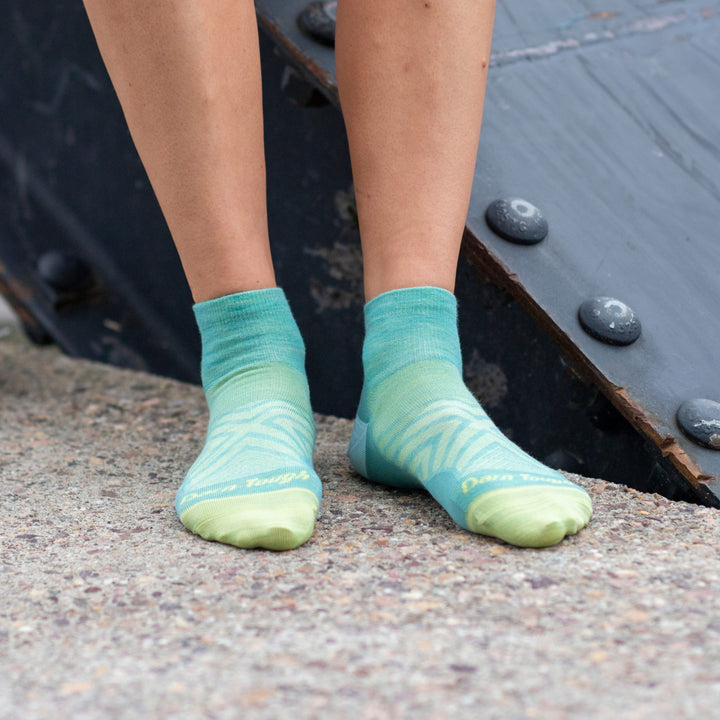 Close up of runner's feet wearing women's no show quarter crew socks in aqua blue