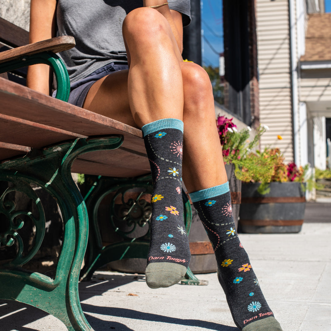 Woman on bench wearing the garden crew everyday floral socks