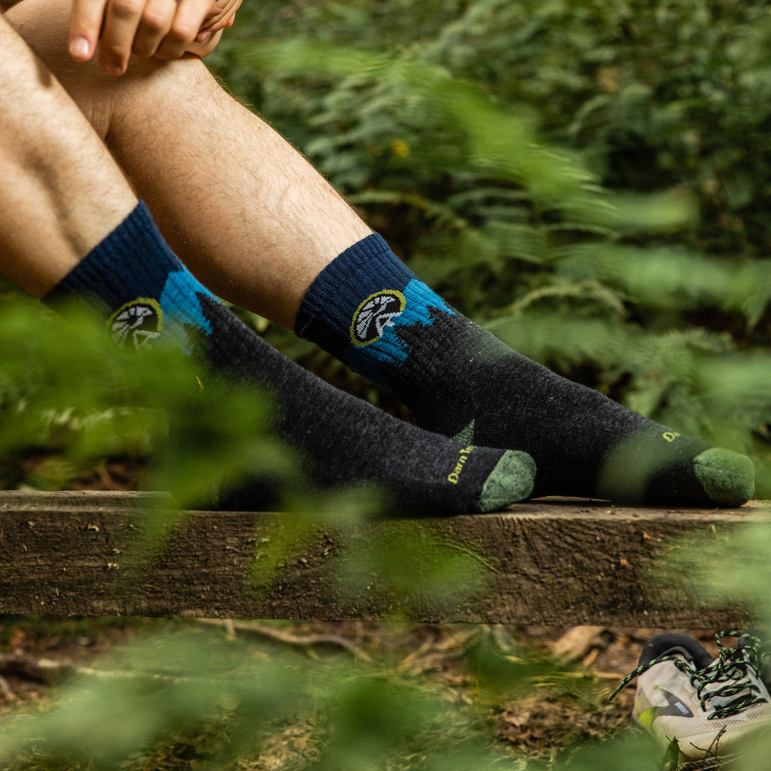 Hiker's feet wearing the Appalachian Trail Conservancy socks that donate back to the ATC