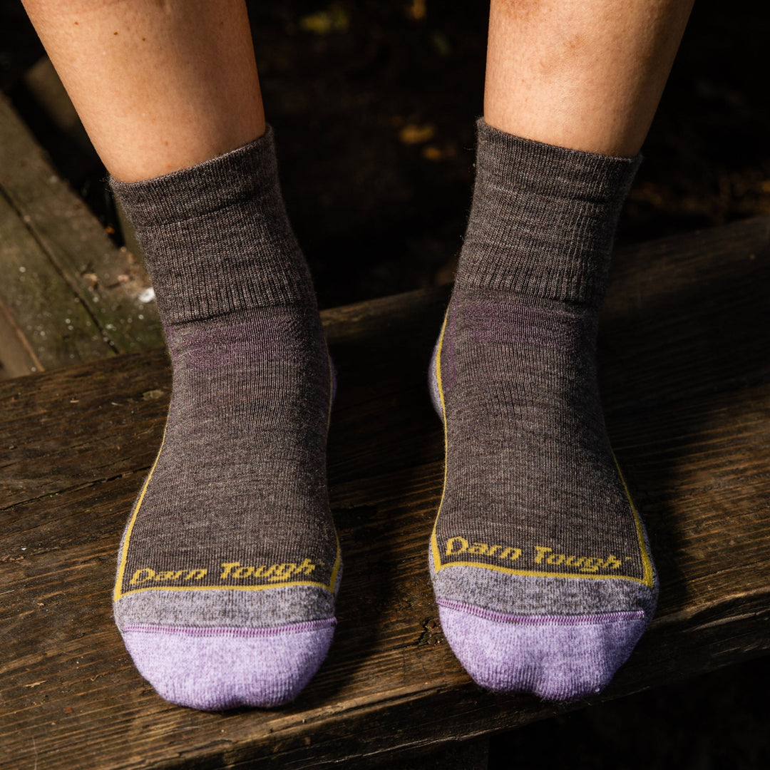 Hiker's feet wearing the women's quarter hiking socks in taupe brown and lavender