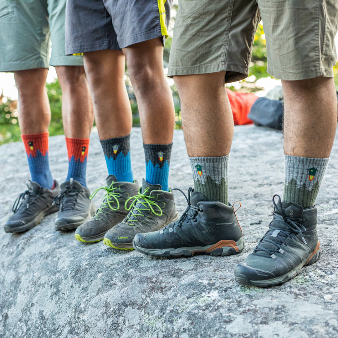 Hikers wearing the Number 2 hiking socks in three different colors, blue, red, and green