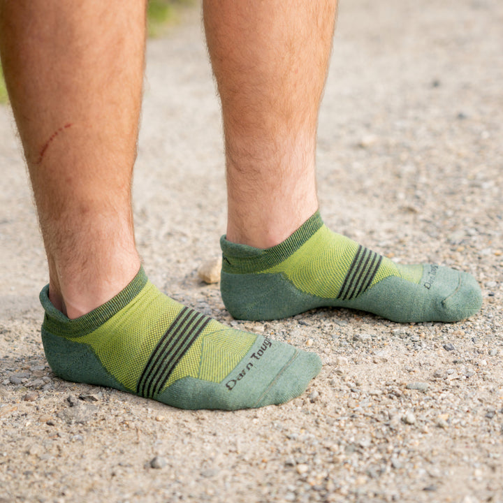 models feet in the sand/dirt wearing the 1116 Now show Element in moss