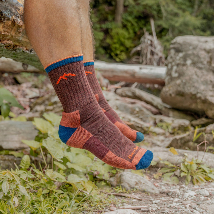 on model image of feet hanging off a rock wearing the 1466 Micro Crew Hiking sock in nutmeg