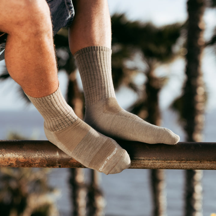Models feet on metal rail wearing the 1657 Standard crew lifestyle sock in rye colorway