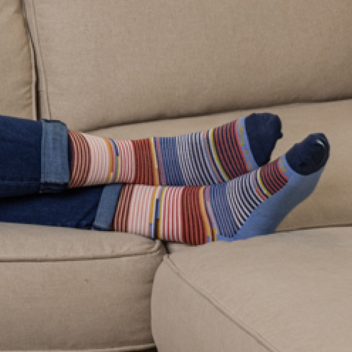 Models feet crossed on a couch wearing the 1692 Pixie Crew Lifestyle sock in Vapor