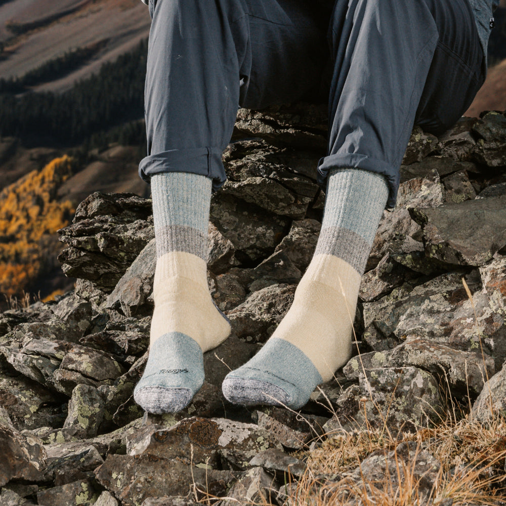 models feet on rocks wearing the 1953 Micro crew Mountaineering sock in Geyser colorway