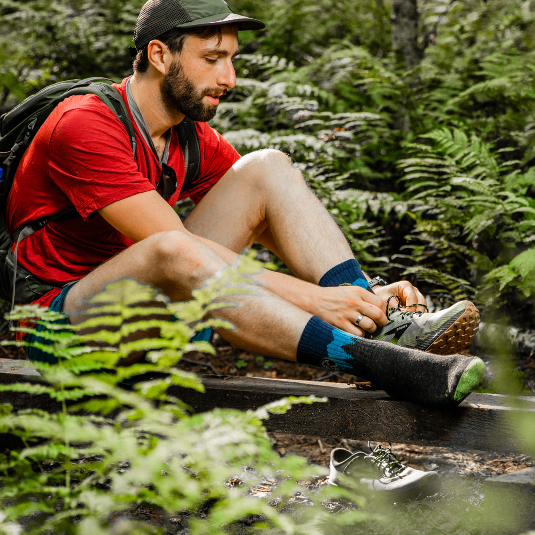 Hiker tying his hiking shoes while wearing the Appalachian Trail hiking socks