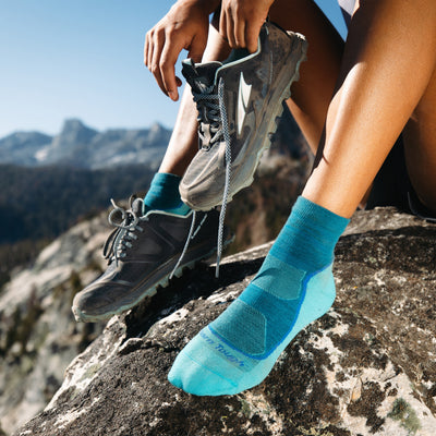 Close up shot of model sitting on a mountain wearing the women&