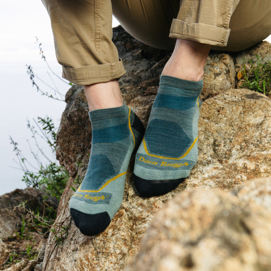 Models feet on a rock wearing the 1990 Light Hiker No Show Hiking sock in Seafoam