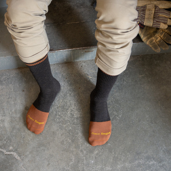 model view from the top with feet in front of stairs wearing the 2006 Steely boot in walnut