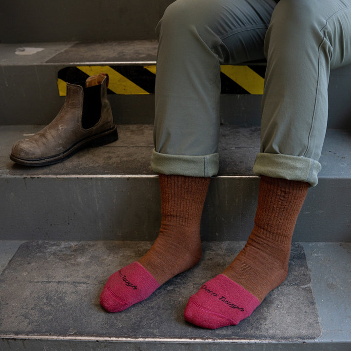 model sitting on stair with feet on the stairs wearing the 2015 women's steely boot in copper