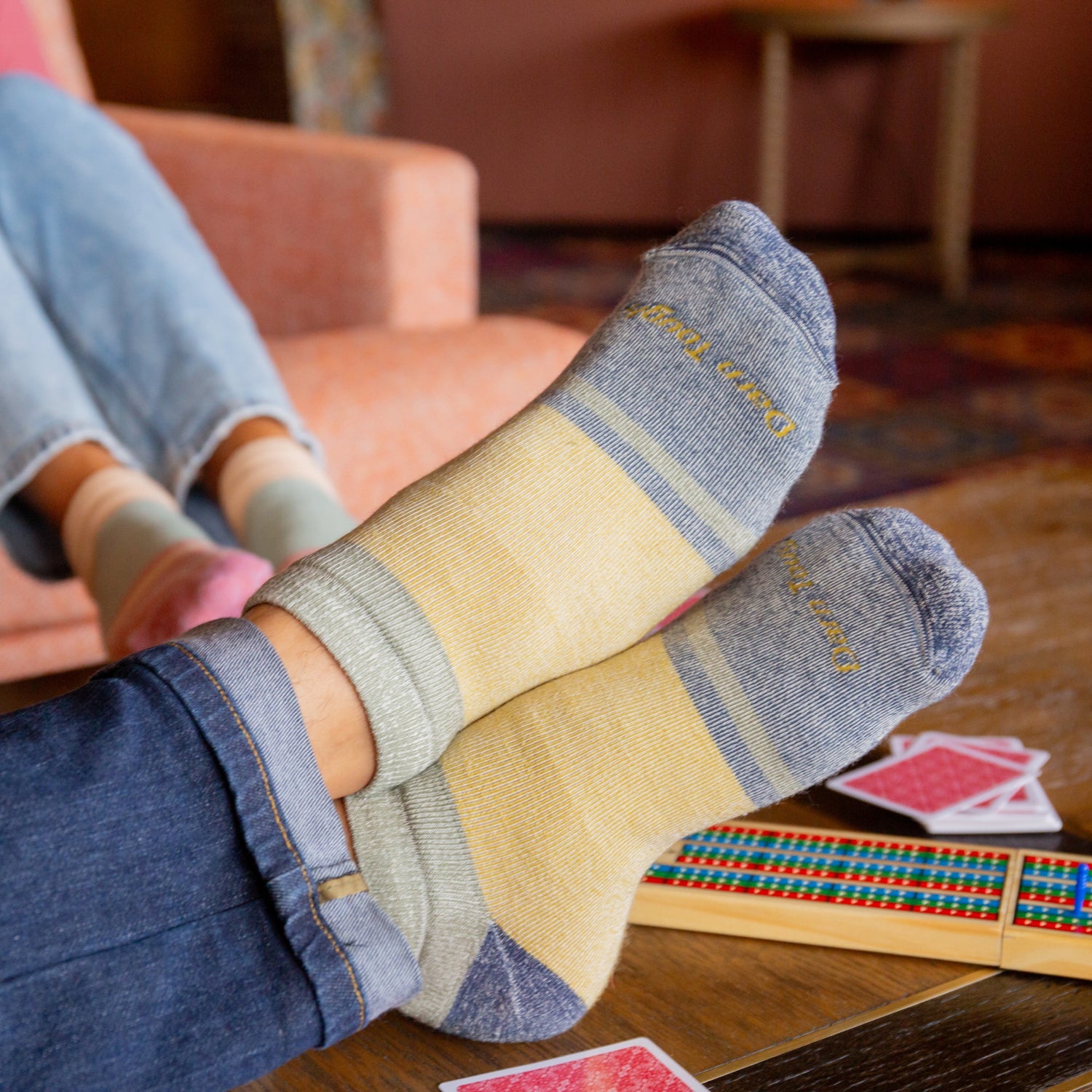 models feel crossed on coffee table wearing the 6128 heavyweight no show in fennel colorway