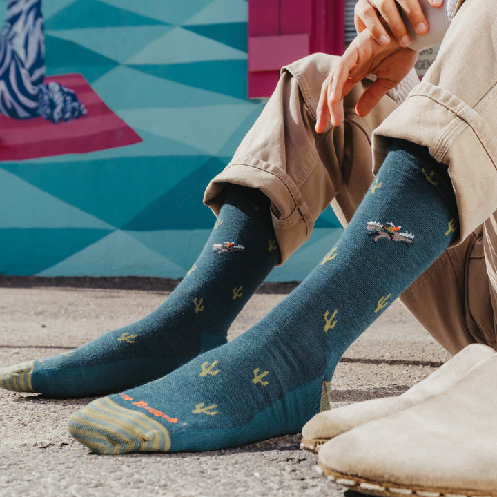 close up models feet next to shoes wearing the 6132 wool'd wool'd west lightweight lifestyle crew in dark teal colorway