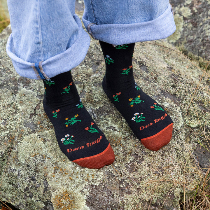 close up of models feet with cuffed jeans standing on a rock wearing 6139 crew lightweight with cushion sock in black