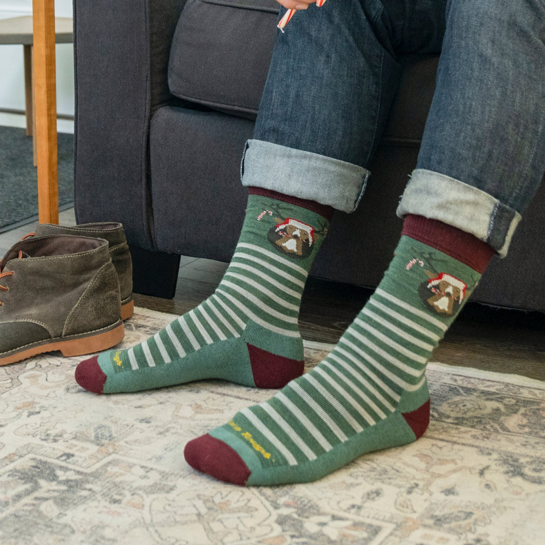On model image of the 6211 Wildlife in evergreen featuring the green/white stripes, red heel/toe, and deer head on ankle