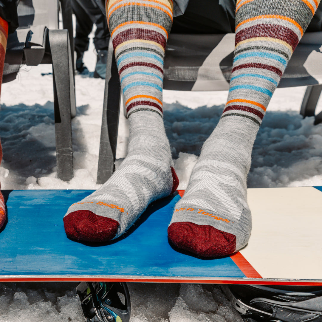 close up on model  with feet on snowboard wearing the 8017 Gray 