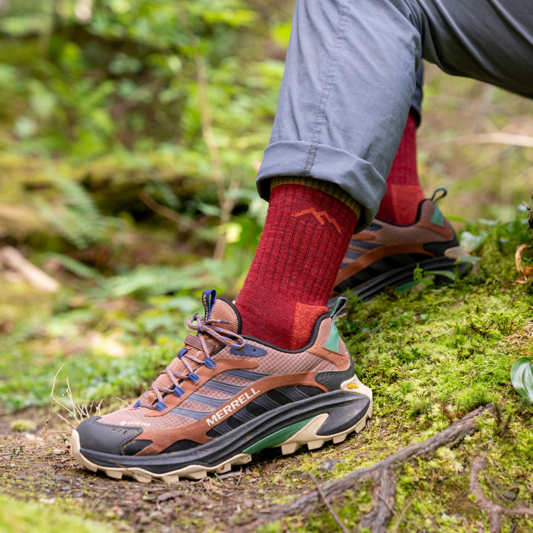 models feet in shoes in the woods wearing the 1466 micro crew hiker in berry 