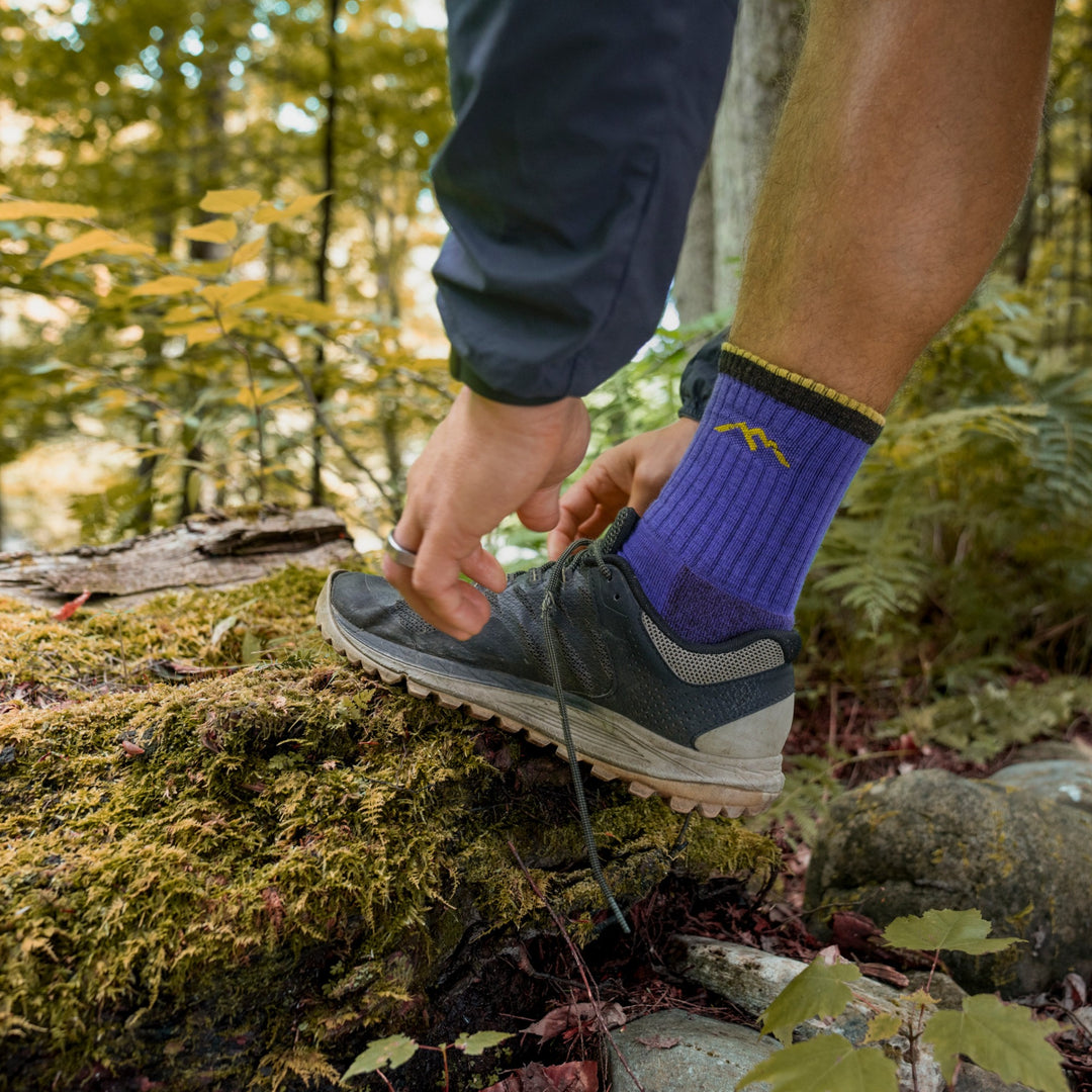 On model image, Tieing a sneaker while wearing the 1466 Micro crew hiking sock in Ultraviolet